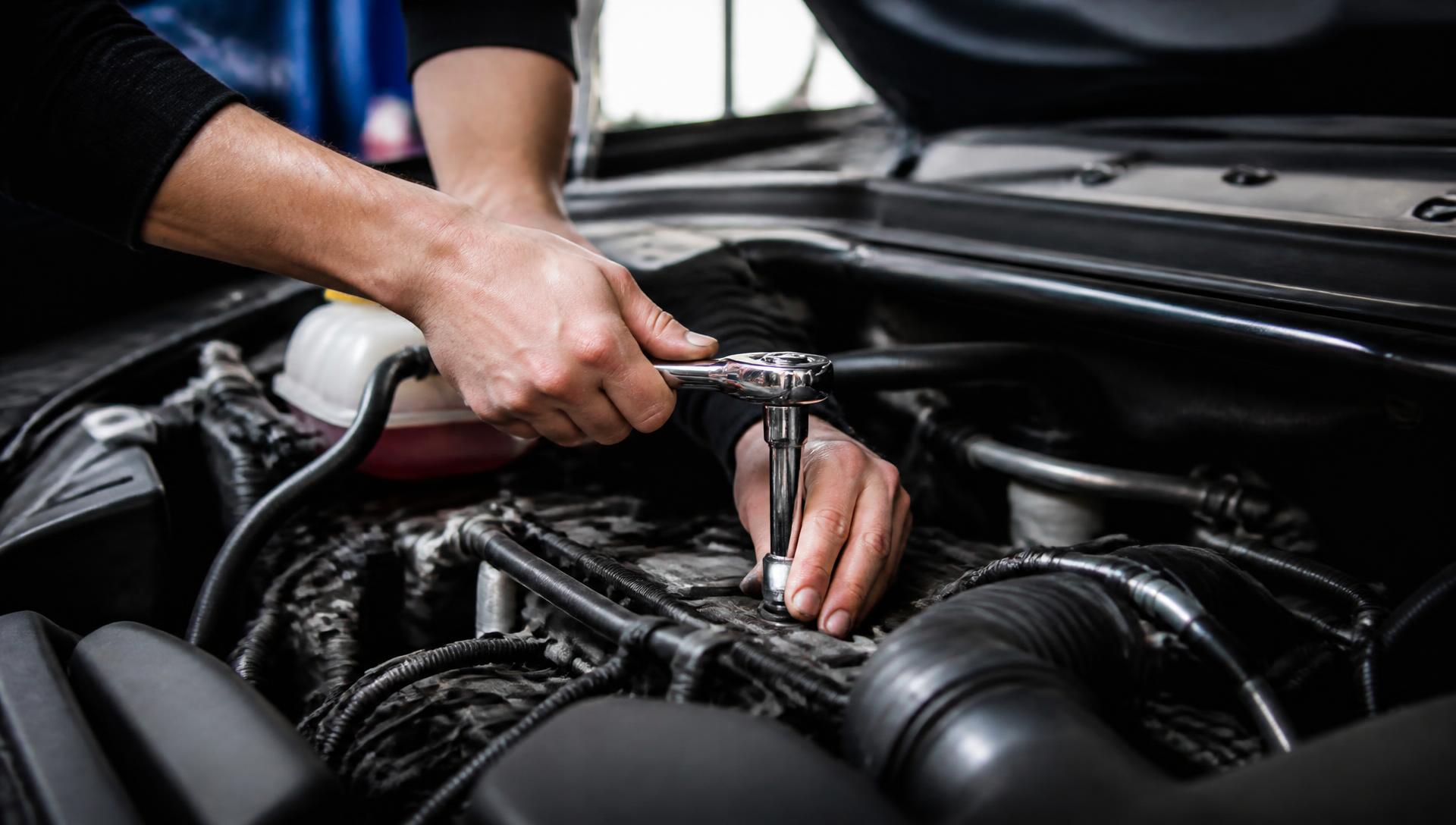 Mechanic using a ratchet spanner on a car engine at the A1 Autocare workshop in Odendaalsrus